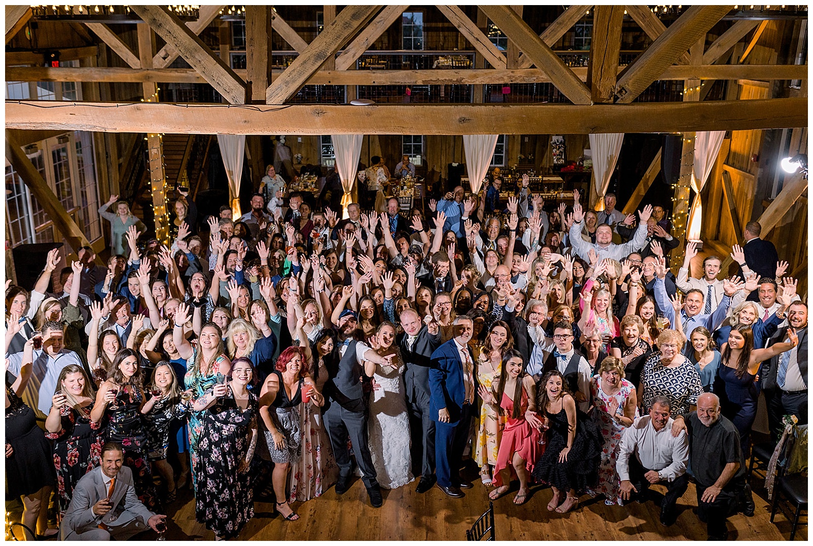 guests gather on the dancefloor to celebrate a wedding reception at wyndridge farm wedding celebration