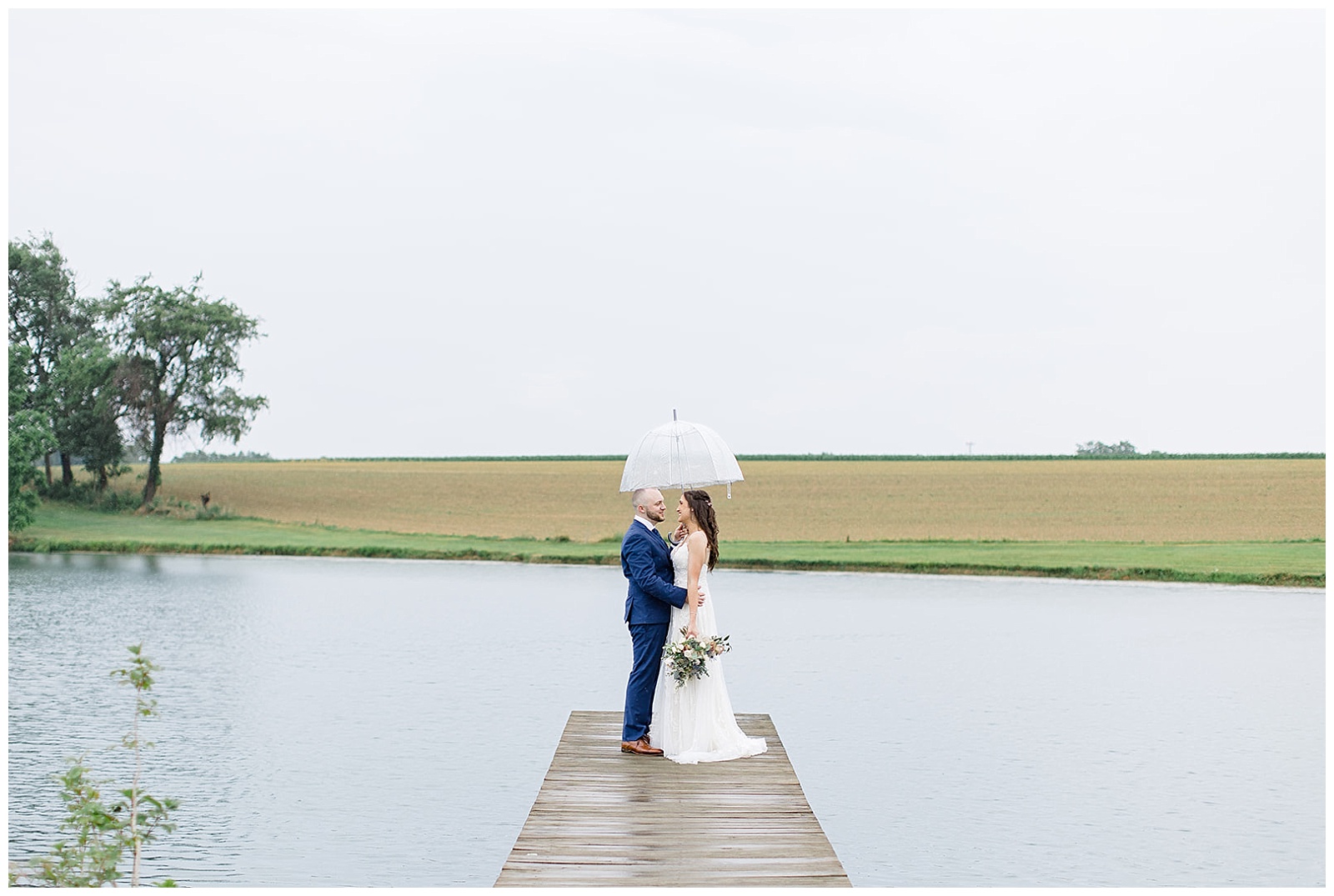 couple takes wedding portraits at lakefield weddings, a modern barn wedding venue