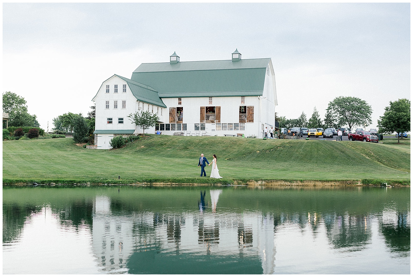 couple takes wedding portraits at lakefield weddings, a modern barn wedding venue