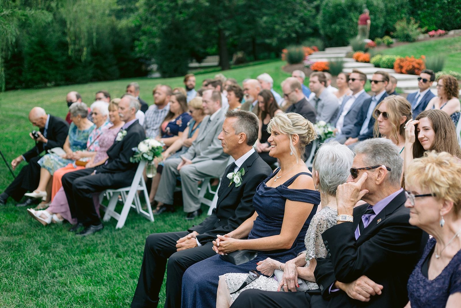 the father and mother of the bride watch tearfully as the couple exchanges vows