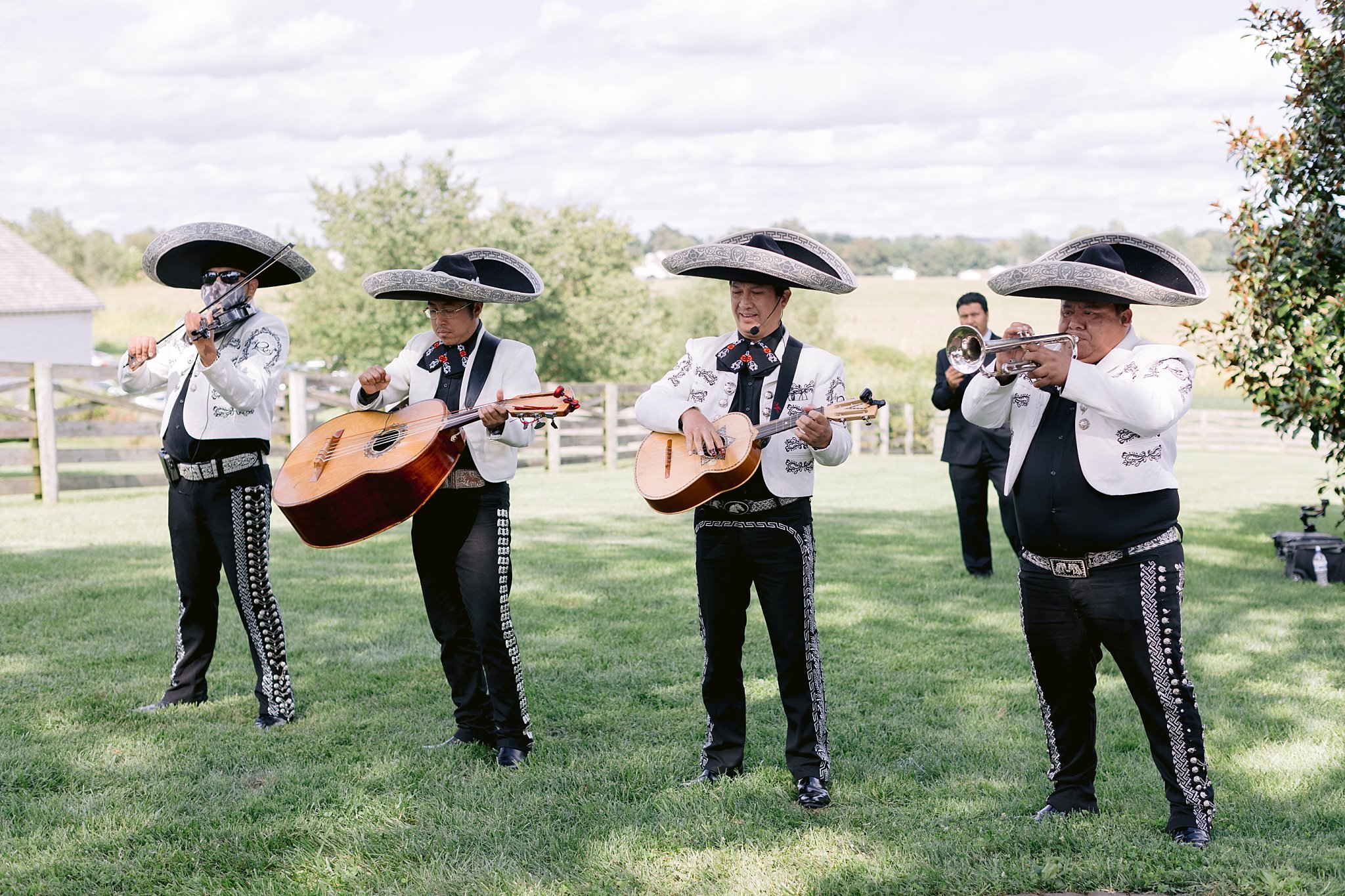 A four man mariachi band plays lively music as the newlywed couple processes down the aisle after their wedding at walkers overlook MD