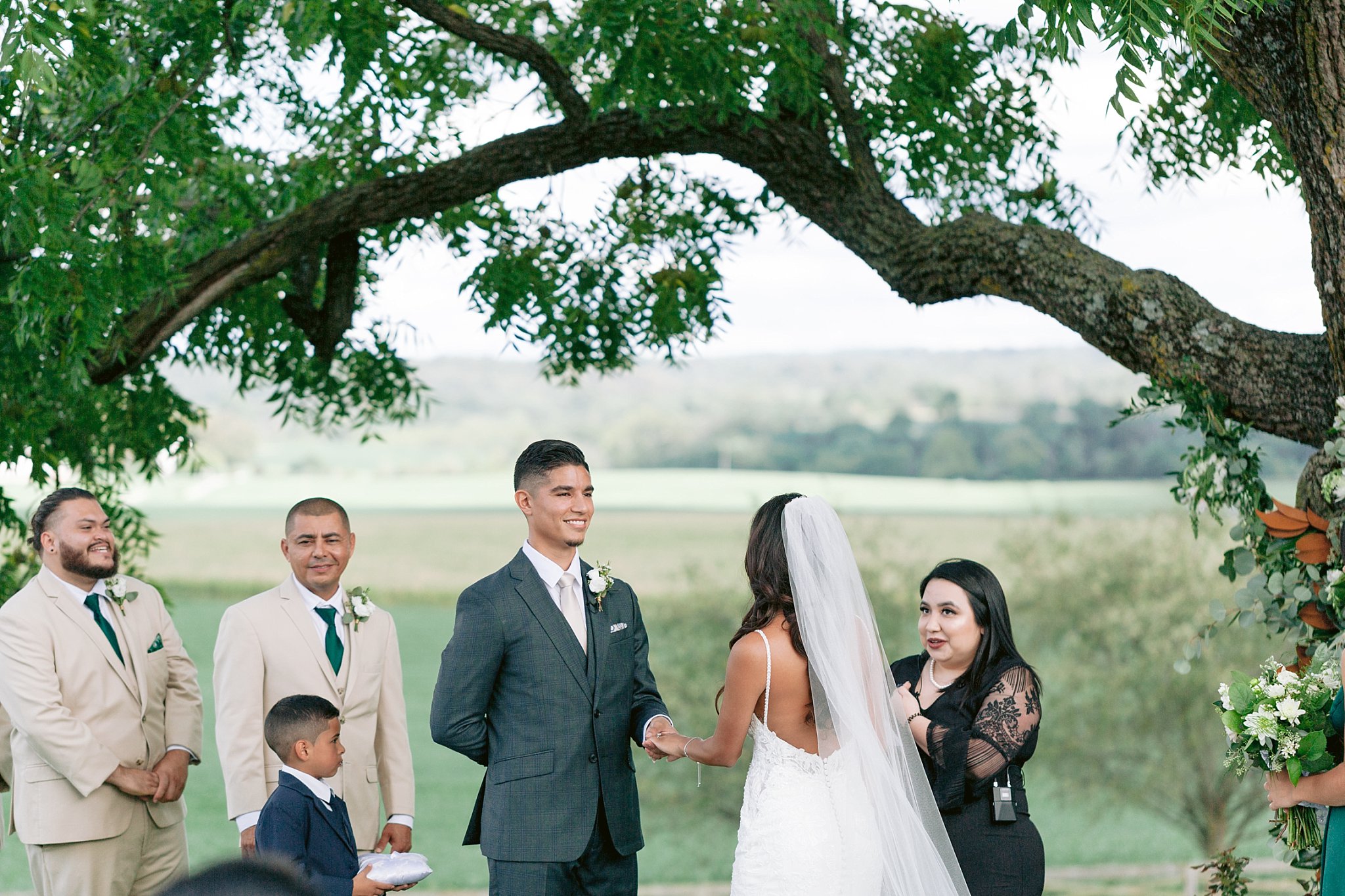 close up image of groom's face during wedding ceremony taking place beneath the large trees at walker's overlook wedding venue in maryland