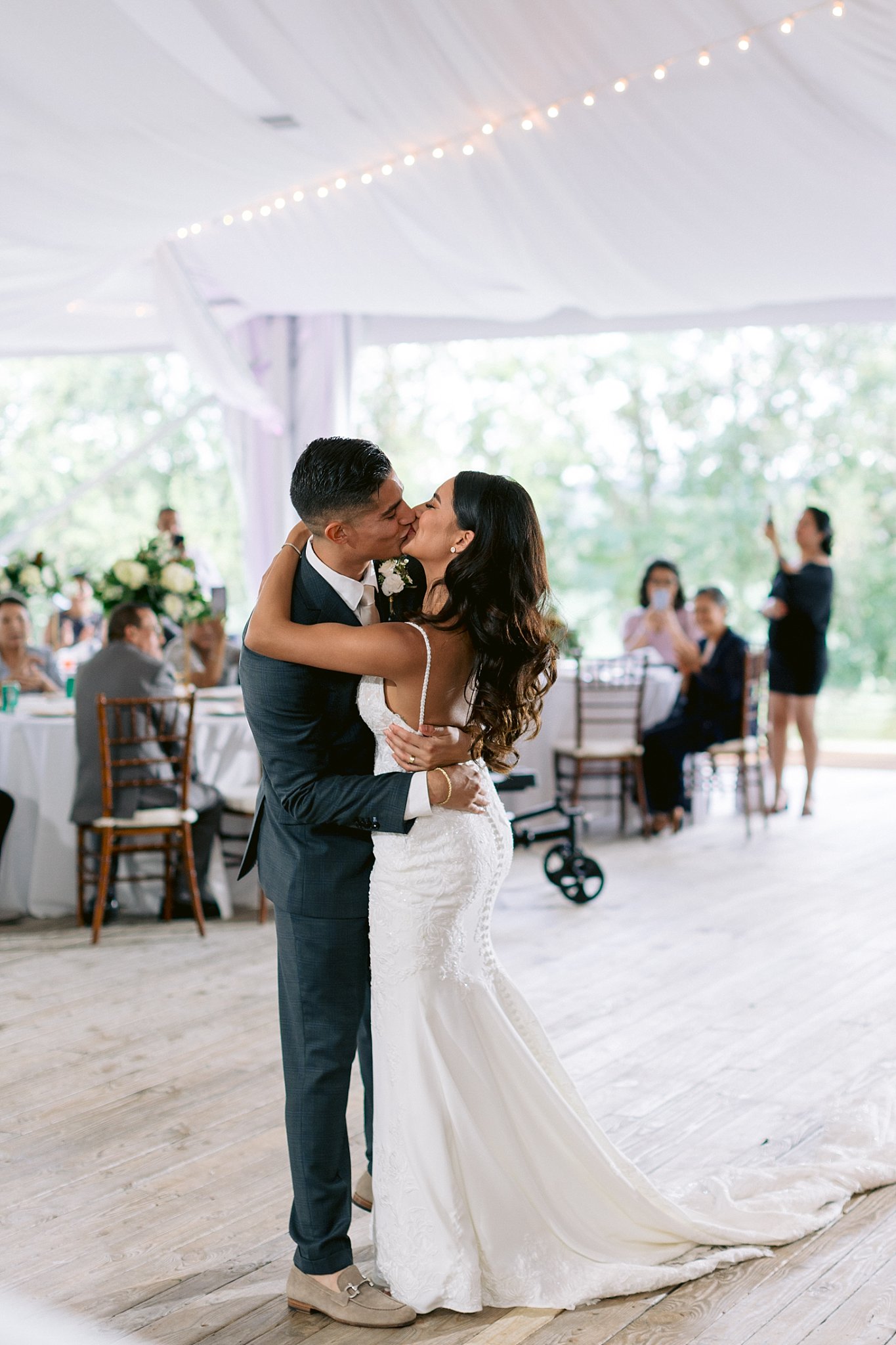 Bride and groom, york college alumni, share a first dance at their tented reception at walker's overlook in MD