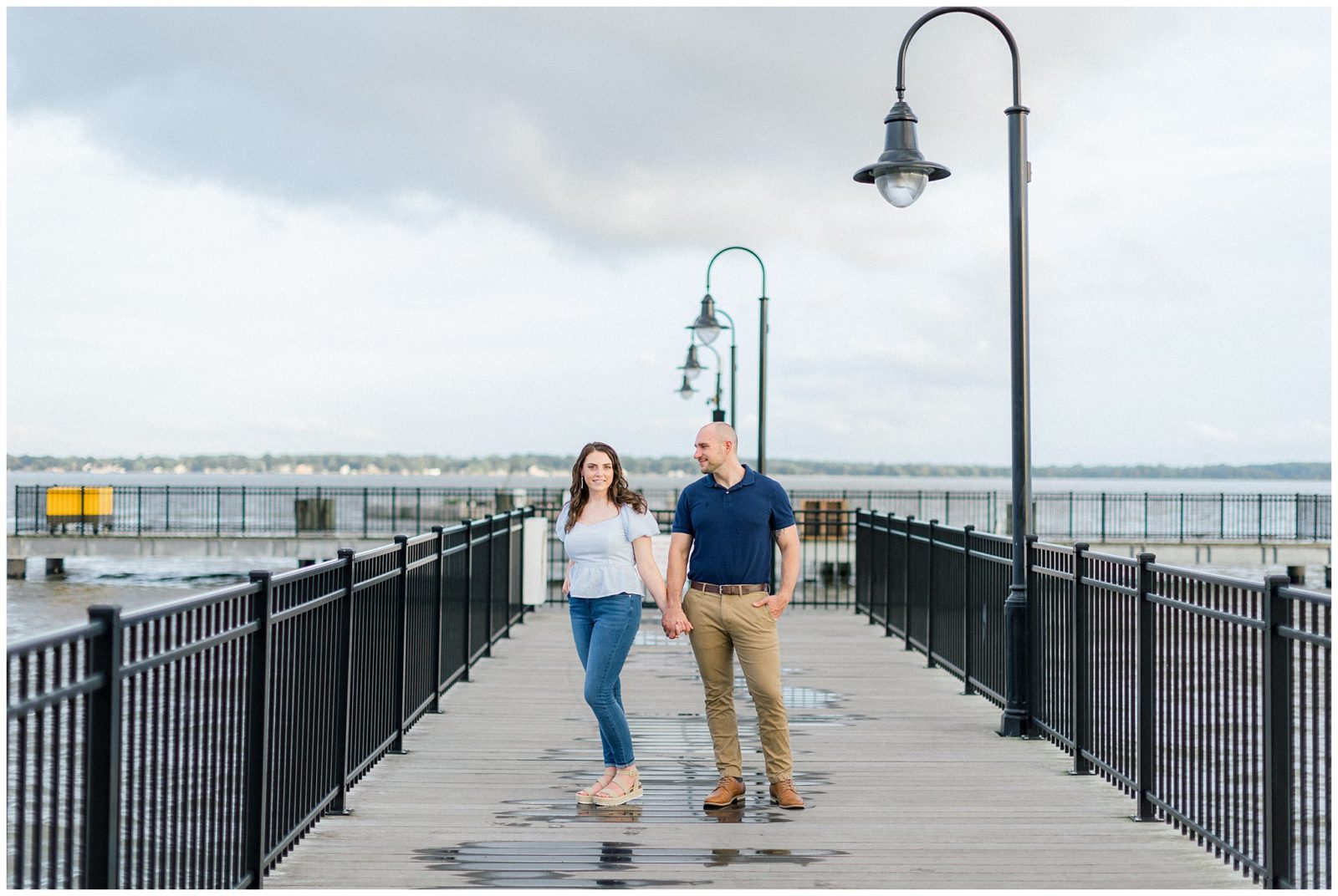 Couple Standing on dock, one looking at the camera