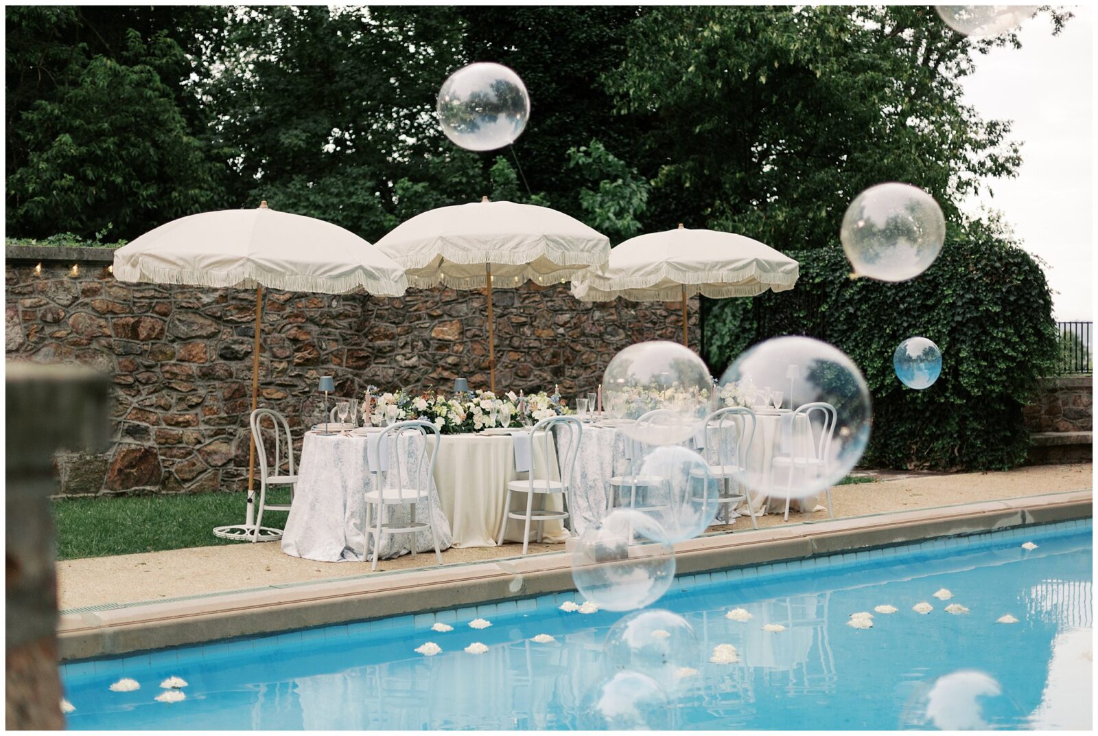 Large bubble balloons surround the pool on site at Lauxmont Farms Wedding 